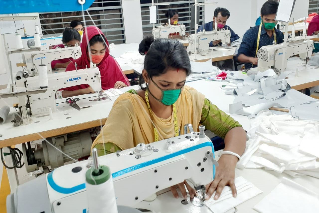 A trainee working on a sewing machine during practical training