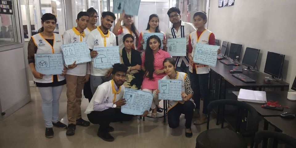 SkillMan trainees holding their certificates in a computer lab